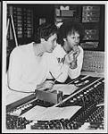 Mike Reno and Paul Dean from the band Loverboy hard at work on their third lp for CBS. The lp is being recorded in Vancouver and is due for release in late spring 1983