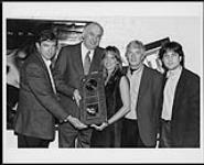 Lynda Lemay receiving a platinum record from Warner Music Canada for her album "Y" in Montreal. Pictured left to right: Dave Tollington, Stan Kulin (Warner Music Canada), Lynda Lemay, Ken Dion, Martin Leclerc (Warner Music Canada) [between 1994-1996].