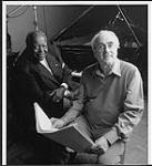 Oscar Peterson and Michel Legrand reading music [between 1990-2000].