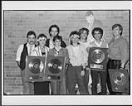 RCA/Current recording artists and multi Casby winners, The Parachute Club receive Platinum and Gold awards for the album and single "At The Feet Of The Moon" [ca 1984].