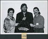 Eddie Rabbitt shows off the tour jacket given as a consumer prize through The Bay in Winnipeg [between 1977-1985].