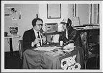 Kim Mitchell and CJBK's afternoon personality, Garry Parsons, live on location at Red Cross Blood Donor Clinic [entre 1982-1985].