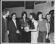 Molly Oliver in Montreal at the Moustache Club. Pictured from left to right: Gary Chalmers (A&R London), Ken Verdoni (V.P. Sales, Marketing and Promotion), Bruce Wheaton, Carson Richards, Ian MacMillan and Michael Leggat of Molly Oliver, and Maurice Mailhot (Quebec Promo London) [ca. 1979].