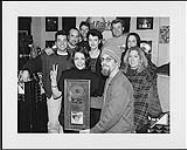 Ashley MacIsaac, Mary Jane Lamond and A&M / Island / Motown staffers during a radio broadcast of CFNY "Live In Toronto". At the event at Toronto's Hard Rock Café, MacIsaac received a platinum award for his major label debut "hiTM how are you today?" MacIsaac and Lamond made the stop during the Toronto leg of the Melissa Etheridge tour, MacIsaac was performing the opening act for the tour. March 18, 1996