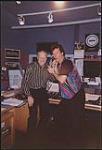 Walter Grealis and an unidentified man in the broadcast booth of a radio station [between 1990-1995].