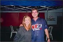KX 96 FM's music director and CMMA nominee, Pete Walker, backstage at Cayuga Speedway with Lee Ann Womack [entre 1997-2000].