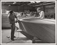 Workers assembling a wooden boat n.d.