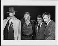 A mannequin with "The Gambler" movie outfit, stands beside Kenny Rogers, Frank Jones and Bill Ivey [ca 1980].