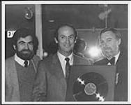 Stephen Posen, a representative of the late Glen Gould's Estate, accepts a gold award for Gould's recording of Bach's Goldberg Variations. Presenting the award were Bernie Dimatteo and Norman Miller, from CBS Records [entre 1982-1983].