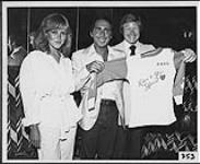 Ed Preston, vice-président et directeur général de RCA Canada, et sa fille Lori remettent à Paul Anka son propre t-shirt personnalisé [ca 1978].