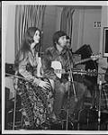 Ian Tyson and Sylvia Tyson sitting in front of microphones [between 1964-1968].
