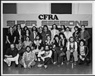 CFRA Ottawa Music Director, Dave Watts and a group of unidentified people gathered in front of a "CFRA Super Sessions" sign [ca. 1978].