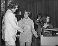 Ron Foster shaking hands with an unidentified man [between 1970-1979].