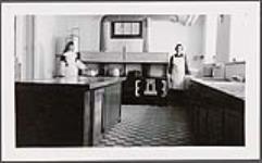 [A nun and another woman in the kitchen at Cross Lake Indian Residential School, Cross Lake, Manitoba, February 1940] February 1940