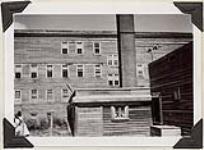 [South end of wing showing smoke stack and additions made to the building, St. Cyprian¿s Indian Residential School, July 14/15, 1941]