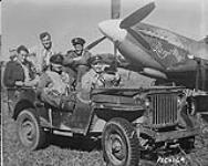 Robert Day in jeep, behind wheel; beside him is F/L C. Simpson, RNZAF, who also shot down two "Oscars" also behind are W/O G.W. Wilson and F/S E.R. Owen and P/O L. Brett 9 January 1945.