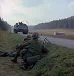Ex Reforger. Germany. Two soldiers of 3 Mech Cdo guard road from ditch as APC vehicle of 1 R22er passes through line during Ex Reforger 74 in Bavaria October 1974.