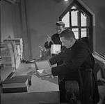 Two Benedictine monks binding books 1950