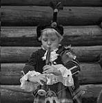 A member of the Girl's Pipe Band from the Gaelic College in St. Ann 1953