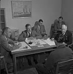 Seated at the table are F. C. Boyes left, Oscar L. Erickson centre, H. C. Grant right, V. H. Goad, social worker, far right; J. D. Rickaby, B.C. Borstal Assoc., centre rear 1954