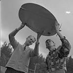 Glen Holm, left, Jack Barnes, and a saucer model 1955