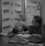 Frank and Bill Edgar work on a new fishing bait 1956