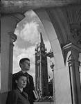 A man and woman in front of the Peace Tower 1957