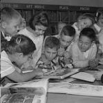 A group of children in a library 1958