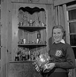 Mrs. Louise Wheeler of St.-Jovite P.Q. with her skiing Trophies. The 1958 World Ski Champion and Canada's Outstanding Women's Amateur Athletic 1958.