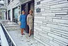 Two women in front of Logexpo facilities [1963-1967]