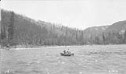 Using canvas boat to cross Wapiti River. Alberta-BC boundary survey 1922