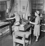 Female workers Eleanor Cowin (left) and Evelyn Gaffin operate lathes machining .22 calibre training rifles in the H.W. Cooey Co. Ltd. munitions plant May 1944