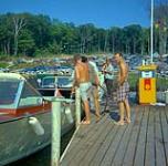 [Group of men refueling a motorboat] [between 1900-1976]