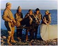 [Five geese hunters standing on a beach] [between 1900-1976]