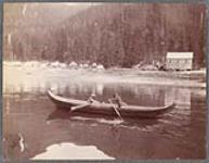 [Two children paddling a dugout canoe during the morning]. Original title: Morning [between 1900-1910].
