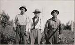 [Anishinaabe men, William, J. Finlayson, and Ambrose Ojikis standing outside] [ca. 1916]