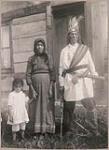 [Family photo of Cayuga Chief Job Hill, wearing a sash and war club, with his daughter and granddaughter] 1912
