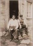 [Peter Taylor and his son seated on the steps of a home] 1912