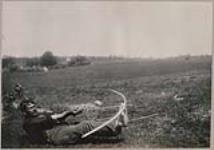 [John Jamieson Jr. practicing archery in lying down position] 1912