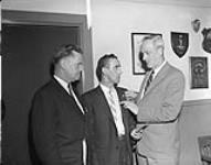 Long Service Presentation. Colonel J.B. Clement presents a service pin recognizing 25 years of service to Mr. J.A.E. Schnobb 13 December 1960.
