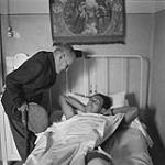Mr. Franck visits Sgt. L.P. Allard, PPCLI in hospital at Melfi. Allard has broken leg 1943