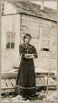 [Inuk woman, identified as Christiane Frey (Mrs. Amos Frey) in long dress wearing white bottom Kamek (sealskin boots)] [between 1921-1922]