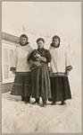 [Three unidentified women, one holding a sled dog puppy] [between 1921-1922]