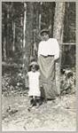 [Anishinaabe woman and child standing outside] 1919