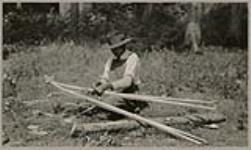 [Anishinaabe man making snowshoes] 1920