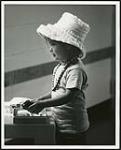 [Child playing dress-up] [ca. 1960-1980]