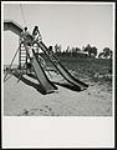 [Children playing on slides] [ca. 1960-1980]