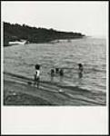 [Children playing at a beach] [ca. 1960-1980]