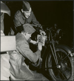 Painting the Maple Leaf on a Regiment de Maisonneuve motorcycle are Ptes. Regis Lebrun and Adrien Pare 2 February 1943