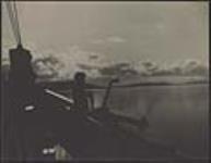 [Man overlooking the side of a Grenfell ship]. Original title: Man standing on the bow of a boat. [ca. 1930].